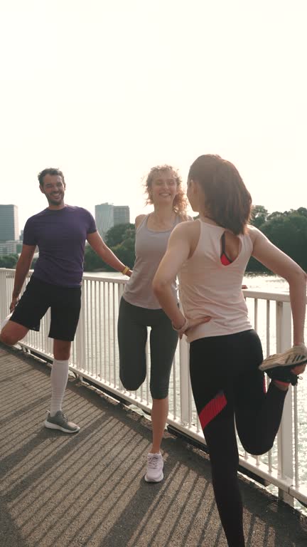 Sporty people doing stretching exercises during running session.