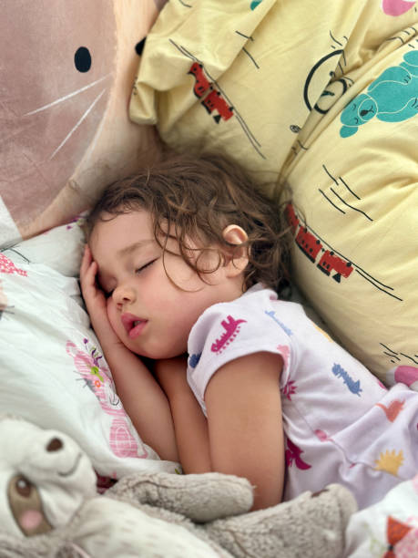 istock Sick little girl sleeping in bed 1512241663
