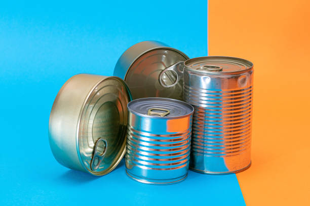 istock A Group of Stacked Tin Cans with Blank Edges on Split Blue and Orange Background 1512276870