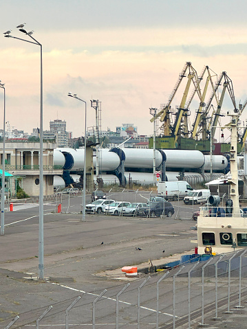 View of very large wind turbine sections at the Port of Constanța at the confluence of the Danube River and the Black Sea.