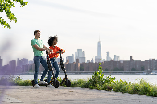 Friends using electric scooter in New Your City