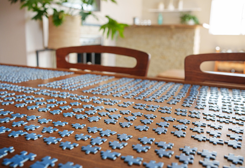 Jigsaw puzzle pieces on table at home