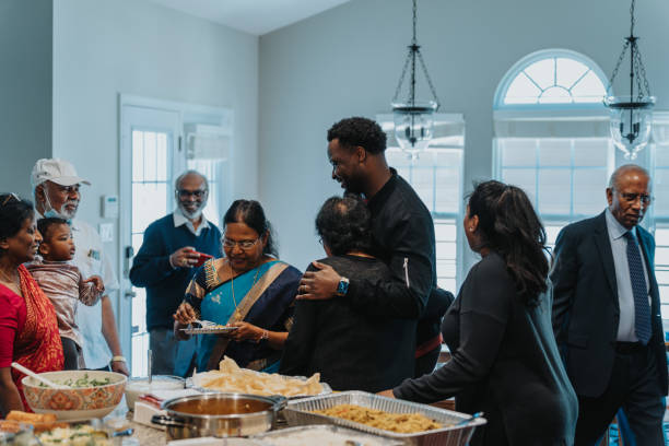 istock Young man hugs an elder woman at a celebration 1512375991