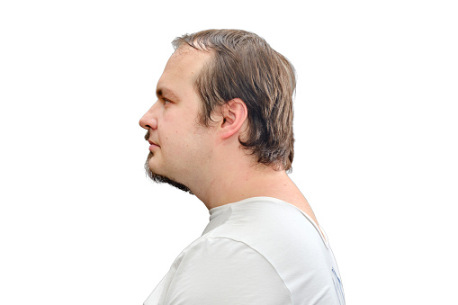 Portrait of a man in a white t-shirt with a half-shaved beard, face profile. Concept of recovery and return to normal life after the coronavirus epidemic, isolated on a white background