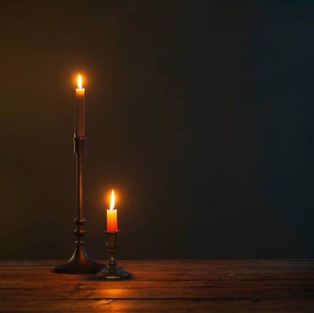 istock burning candles in vintage candlesticks on dark background 1512399488