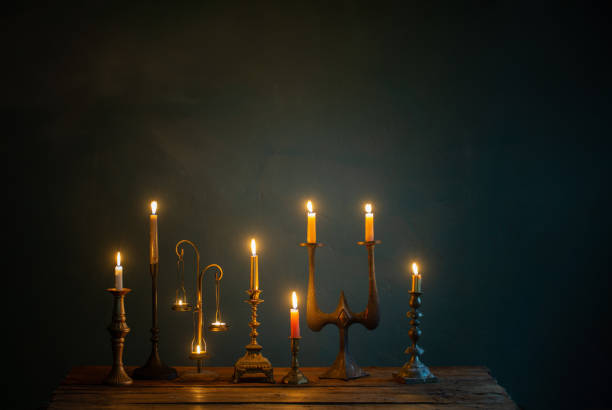 istock burning candles in vintage candlesticks on dark background 1512399491