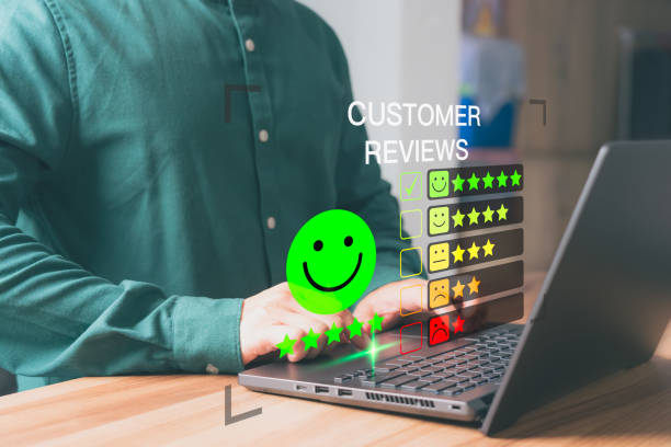 istock Customer use a computer laptop with a pop-up smile face and five star icon for assessment feedback review satisfaction and testimonial. Customer service experience and business satisfaction survey. 1512420128
