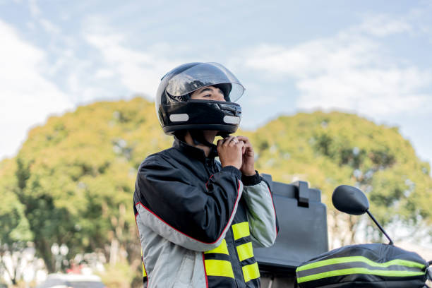 Delivery man removing helmet.