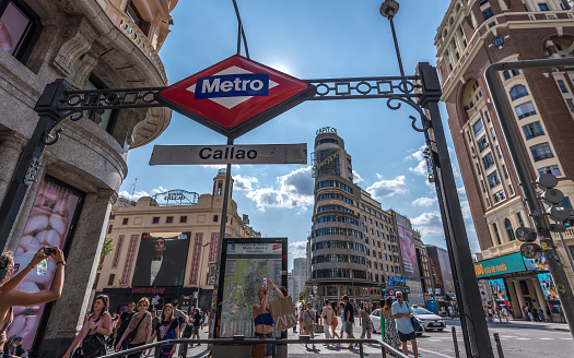 Madrid, Spain - June 22, 2023: Ordinary people and tourists stroll along Plaza de Callao next to Gran Via, in Madrid on a hot summer day. The Plaza del Callao was built between 1917 and 1922. Currently, 113 million people pass through it annually.