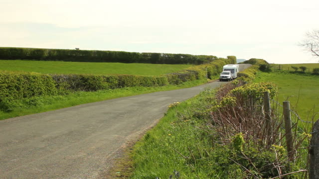 Caravan trailer travelling being towed through the countryside