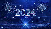 Happy New Year 2024 festival technology concept celebration. slow motion bokeh particle confetti and fireworks glittering on a dark blue background.