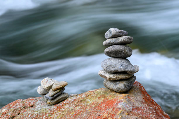 Cairn beside a river A stack of stones beside a river silbertal stock pictures, royalty-free photos & images