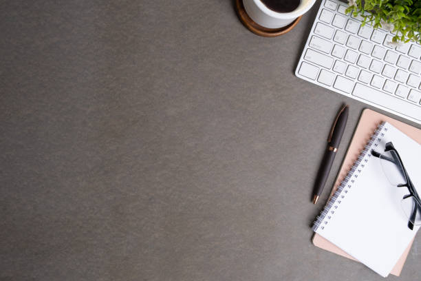 istock Flat lay eyeglasses, coffee cup, keyboard and potted plant on grey table. Copy space for text. 1512532783