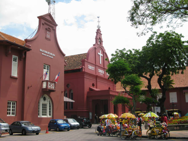 the melaka art gallery beside christ church melaka in downtown melaka or malacca which was built by the dutch in the 18th century in a bright red colour as were many of the dutch buildings during this period. it is a popular tourist destination in malaysi - cyclo cross imagens e fotografias de stock