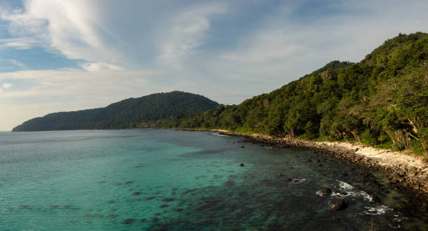 Tropical beach, turquoise water and coastline of Weh island, Indonesia. Tropical beach, bay, turquoise water, tropical trees and wild coastline of Secret Beach, Weh island, Sabang, Sumatra, Indonesia. sabang beach stock pictures, royalty-free photos & images