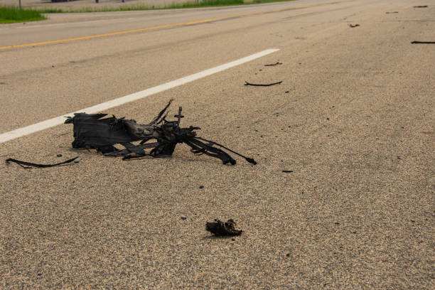 istock Tire fragments on roadway create traffic hazard. 1512646576