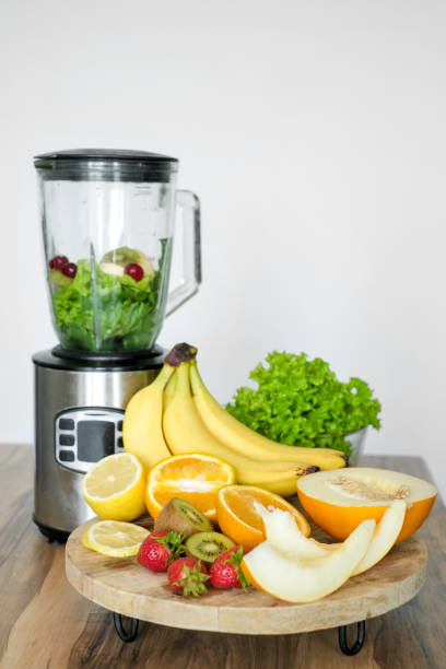 istock Blender with ingredients for smoothie and products on wooden table in kitchen 1512805794