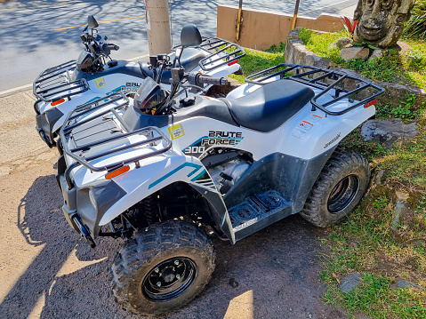 A black atv in a winter setting.