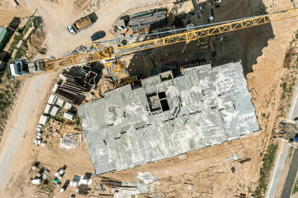 istock construction site with crane, construction materials and heavy equipment. aerial top view. 1512871995