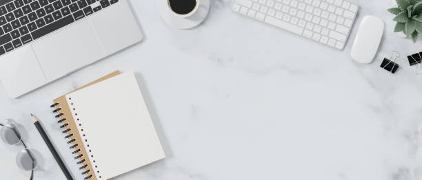 istock Top view of modern workspace with blank notebook, office supplies and copy space. 1512882718