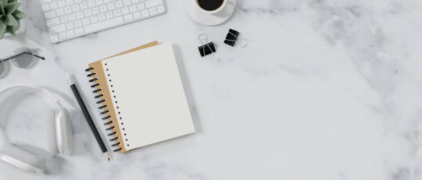 istock Top view of modern workspace with blank notebook, office supplies and copy space. 1512882719