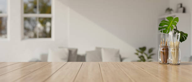 istock Empty wooden table top with copy space with sofa in living room background. 1512883234