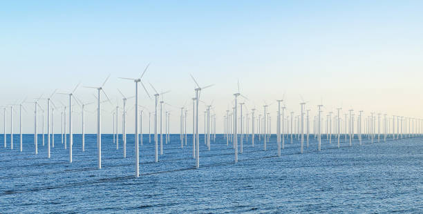 istock Renewable energy concept with wind mill farm against blue sky 1512910848