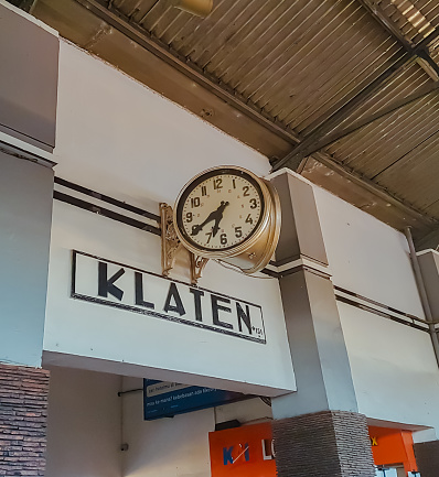 Klaten, Indonesia - June 30, 2023 : Old antique clock on the platform wall of Klaten Station