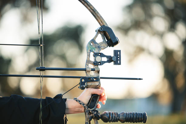 istock Archery bow closeup and woman hands at shooting range for competition, game or learning in field or outdoor sports.  Person with arrow for gaming, adventure and hunting with aim and target practice 1512944613