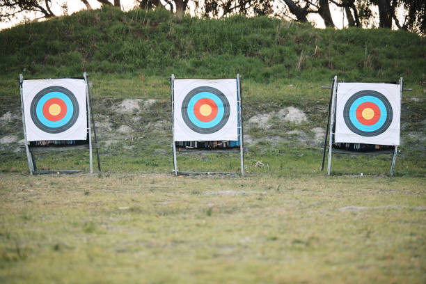 istock Bullseye target board, outdoor and field at shooting range for weapon training, aim and accuracy. Sports, archery and poster for gun, bow and arrow at academy for police, army or security in nature 1512944629