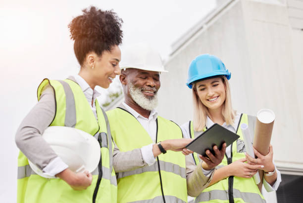 Architecture, teamwork and people with tablet for engineering, city construction and planning. Collaboration, building and happy man and women on digital tech for inspection, maintenance and project