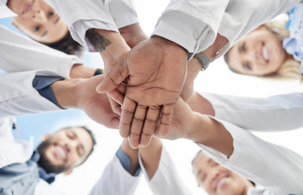 istock Hand stack, doctors and below group with smile for motivation, success and team building in hospital. People, teamwork and hands together for solidarity, support and goals for healthcare in clinic 1512945655