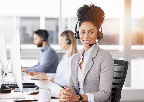 Happy, portrait and woman call center agent working on online consultation in the office. Crm, smile and African female customer service, telemarketing or sales consultant with headset in workplace.