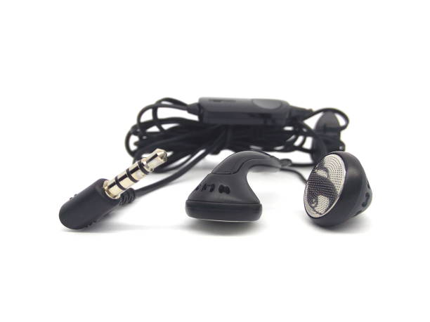 istock Black wired earphones or earbuds isolated on white background. 1512958829