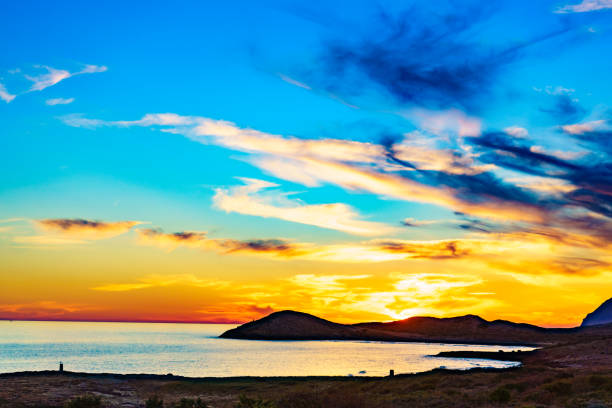 Sunset over sea. Seaside evening landscape. Calblanque Beach, Murcia Spain.