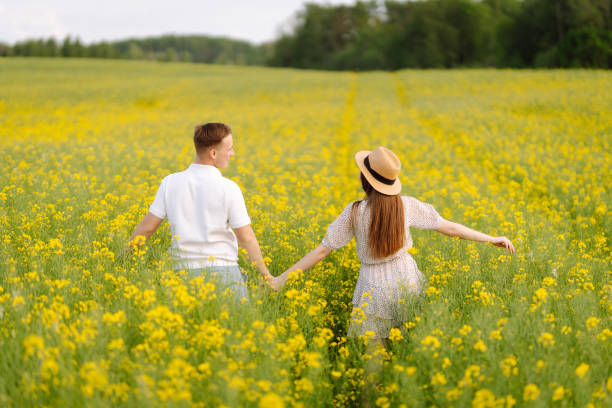 istock Young Couple in the blooming field. 1513071822