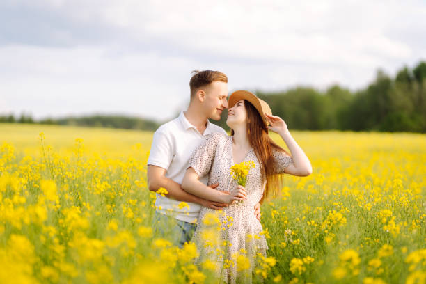 istock Young Couple in the blooming field. 1513071851