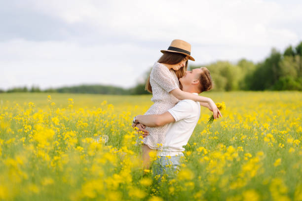 istock Young Couple in the blooming field. 1513072379