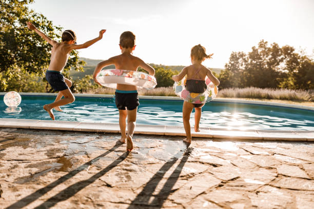 istock Playful siblings having fun during summer day at the pool. 1513072926