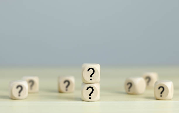 istock Question marks, confused, thinking, brainstorming or making decisions, on wooden blocks. White background. 1513074510
