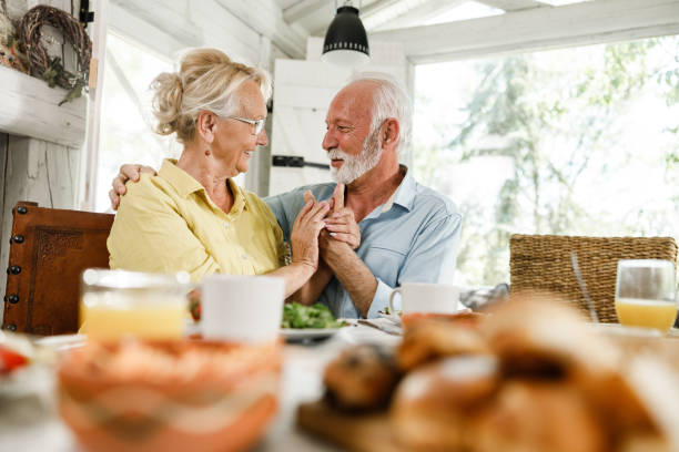 istock Embraced senior couple talking during a meal in dining room. 1513075575