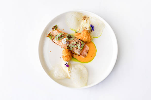 Salmon fillet in mango sauce with fried cheese balls isolated