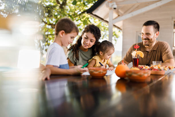 istock Happy family enjoying while coloring in the backyard. 1513077183