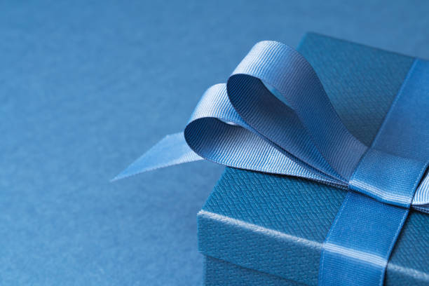istock Part of gift box with a blue bow on blue 1513094548