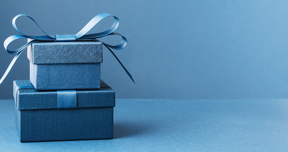 Silver gift boxes with blue ribbon on white. This file contains 
