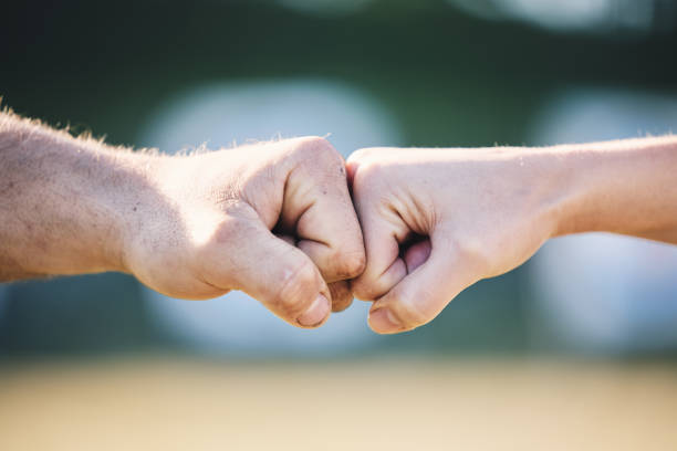 istock Fist bump, hands and outdoor with touch, teamwork and greeting for respect, support and motivation. Man, woman and hand together for connection, partnership and team building for sport, deal or goal 1513104260