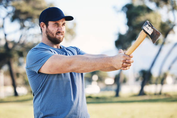 istock Sports, archery and man throw axe on range for training, exercise and target practice competition. Extreme sport, fitness and male archer aim with tomahawk weapon for action, games and adventure 1513104273