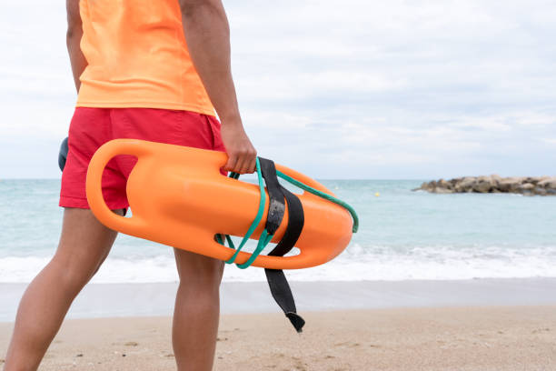 istock Coastguard walking with a float on a beach watch 1513111843