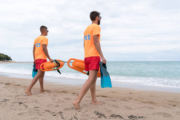 istock Lifeguard staff walking with a float watching on the beach 1513111844