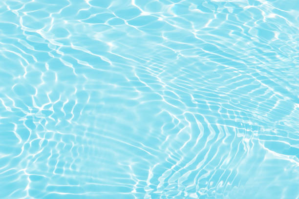 istock Blue water with ripples on the surface. Defocus blurred transparent blue colored clear calm water surface texture with splashes and bubbles. Water waves with shining pattern texture background. 1513154821